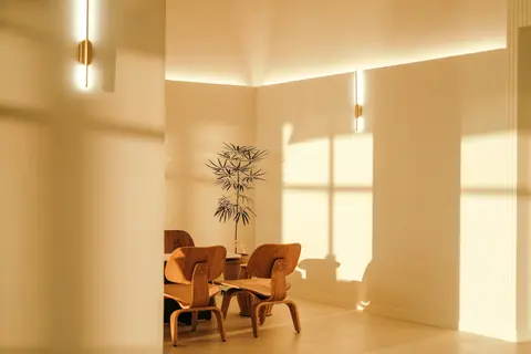 Moderner Essraum mit warmem Sonnenlicht und Holzstühlen