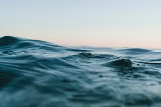 Sanfte Wellen auf stiller Wasseroberfläche im Abendlicht